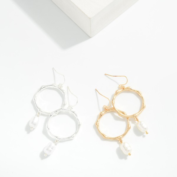 Metal Tone Bamboo Drop Hoop Earrings Featuring Rice Pearl Detail 

- Approximately 2" L