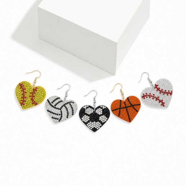 Soccer Heart Rhinestone Drop Earrings — pave crystal hearts styled with a classic soccer ball pattern on lightweight fishhook wires. Densely set stones catch the light from the sideline, while the heart silhouette keeps the look sweet instead of sporty-plain. A go-to for soccer moms, players, team gifts, senior nights, and tournament weekends. Priced as an easy impulse add-on, these game-day earrings sell through fast every season for boutiques in soccer towns.