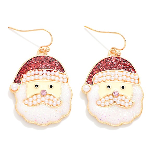 Pearl Trim Santa Face Drop Earrings featuring a glitter Santa hat with a faux pearl brim and pom, a pearl studded mustache, a sparkling crystal nose, and a shimmering glitter beard on lightweight fishhook wires. The mix of pearls and glitter gives a classic character an elevated, dressy finish. Perfect for Christmas parties, church events, and holiday photos. Sparkly Santa styles are perennial holiday bestsellers that customers come back for every year.