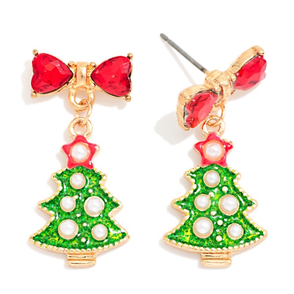 Crystal Bow Christmas Tree Drop Earrings featuring a glitter enamel tree dotted with faux pearl ornaments and a star topper, hanging from a sparkling heart cut crystal bow post. The bow detail adds a dressy, feminine touch to a classic holiday shape. Lovely for Christmas parties, church services, and festive family photos. Bows and pearls are two of the season's biggest trends, making this an easy, quick turning holiday style.