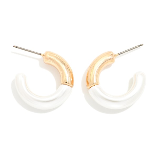 Two Tone Tube Hoop Earrings featuring a sleek open tube hoop with a polished metal section up top and a glossy enamel finish wrapping around the rest for a clean, color block look. The slim, rounded shape is lightweight and comfortable on a simple post back. A modern everyday hoop that dresses up tees and sweaters or adds polish to office wear. Fresh two tone styles like this are an easy add on for customers who already own the basics.