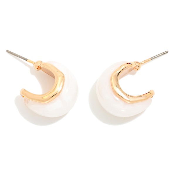 Half Dipped Chunky Hoop Earrings featuring a puffy open hoop that blends a polished metal top with a glossy enamel finish on the lower half for a modern, color block effect. The chunky shape makes a statement while staying lightweight on a simple post back. An easy everyday style that pairs with knits, denim, and workwear. Two tone hoops are trending and give boutique shoppers a fresh update on a classic silhouette.