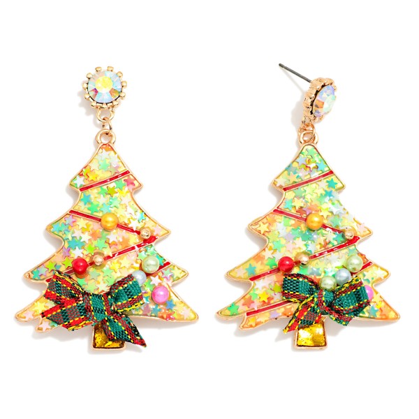 Confetti Christmas Tree Drop Earrings featuring a tree shaped resin charm filled with glitter, star confetti, and tiny pearls, finished with a gingham ribbon bow and a sparkling rhinestone post. The shaker inspired fill catches the light with every move for a playful, sweet holiday look. A favorite for Christmas parties, classroom celebrations, and holiday photos. Bows, glitter, and confetti make these a trend right impulse buy for every age.