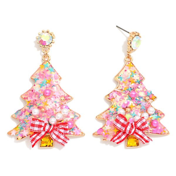 Confetti Christmas Tree Drop Earrings featuring a tree shaped resin charm filled with glitter, star confetti, and tiny pearls, finished with a gingham ribbon bow and a sparkling rhinestone post. The shaker inspired fill catches the light with every move for a playful, sweet holiday look. A favorite for Christmas parties, classroom celebrations, and holiday photos. Bows, glitter, and confetti make these a trend right impulse buy for every age.
