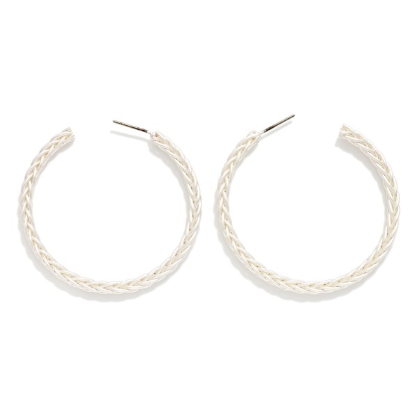 Braided Texture Open Hoop Earrings featuring a slim, open front hoop etched with a woven braid pattern and finished in a soft matte metal tone. The textured surface adds subtle dimension, while the lightweight post design keeps them comfortable all day. An easy everyday hoop that works with casual weekend outfits, workwear, and western looks alike. Versatile, giftable, and priced to move, textured hoops are a staple reorder for boutique jewelry walls.