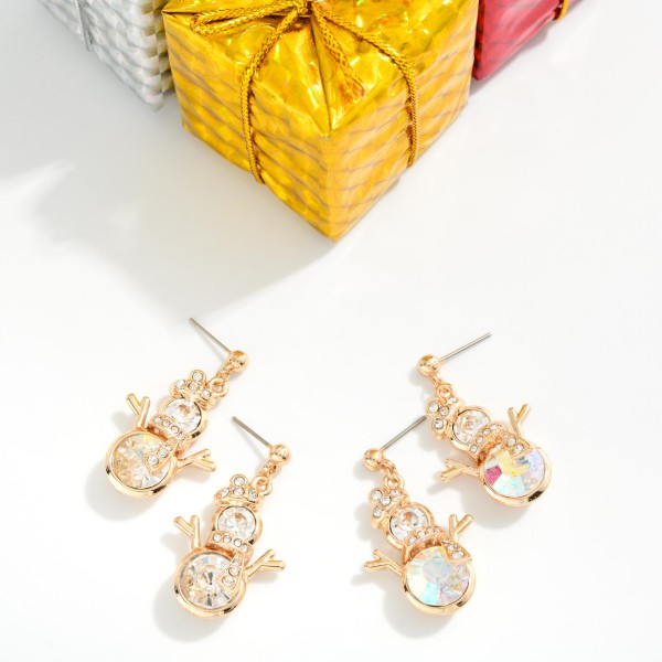 Crystal Snowman Drop Earrings featuring a sparkling snowman built from two faceted crystal stones, with a rhinestone hat, scarf, and twig arms on a petite ball post. The oversized stones catch light from every angle, giving this winter character a dressy, elegant twist. Perfect for holiday parties, winter weddings, and festive date nights. Sparkly seasonal earrings like these make easy gifts and sell from November straight through January.