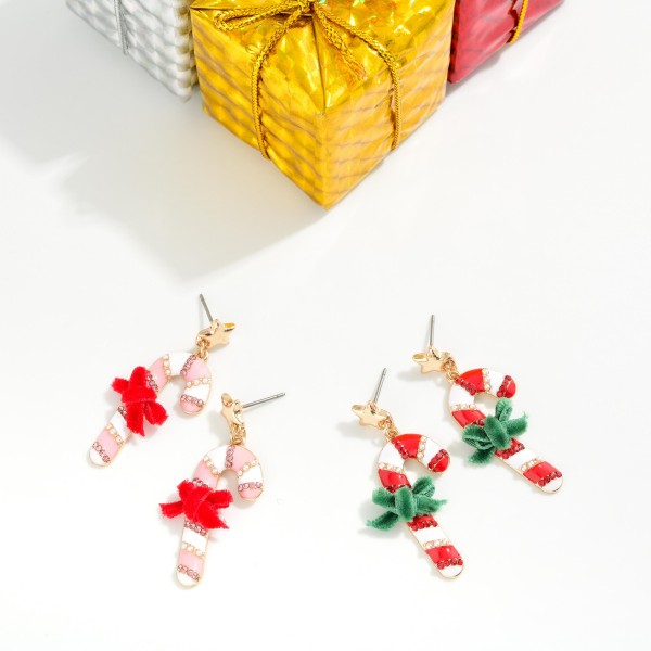 Enamel Candy Cane & Metal Tone Star Post Drop Earrings Featuring Felt Bow Detail 

- Approximately 1.5" L 