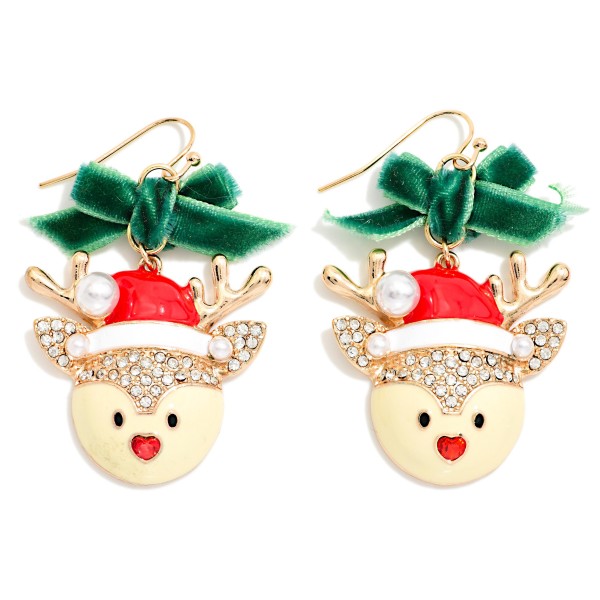 Velvet Bow Reindeer Drop Earrings featuring a sweet enamel reindeer face in a Santa hat with rhinestone trim, a pearl pom, sparkling antlers, and a tiny heart nose, hanging below a soft velvet bow on fishhook wires. The mix of velvet, sparkle, and enamel gives a dressy, trend right holiday look. A darling pick for Christmas parties, church events, and festive family photos. Bows and character earrings are top sellers this season, so expect these to move quickly.