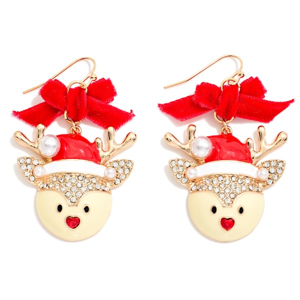 Velvet Bow Reindeer Drop Earrings featuring a sweet enamel reindeer face in a Santa hat with rhinestone trim, a pearl pom, sparkling antlers, and a tiny heart nose, hanging below a soft velvet bow on fishhook wires. The mix of velvet, sparkle, and enamel gives a dressy, trend right holiday look. A darling pick for Christmas parties, church events, and festive family photos. Bows and character earrings are top sellers this season, so expect these to move quickly.