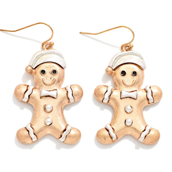 Vintage Metal Gingerbread Man Drop Earrings featuring a smiling gingerbread cookie in a cozy Santa hat, complete with a bow tie, buttons, and icing trim, all in a worn, burnished metal finish. Lightweight fishhook wires keep them easy to wear through long holiday events. A sweet pick for cookie swaps, baking parties, teachers, and holiday markets. Playful and nostalgic, gingerbread designs are a dependable seasonal seller and a perfect stocking stuffer.