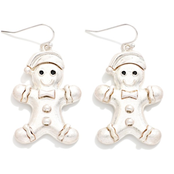 Vintage Metal Gingerbread Man Drop Earrings featuring a smiling gingerbread cookie in a cozy Santa hat, complete with a bow tie, buttons, and icing trim, all in a worn, burnished metal finish. Lightweight fishhook wires keep them easy to wear through long holiday events. A sweet pick for cookie swaps, baking parties, teachers, and holiday markets. Playful and nostalgic, gingerbread designs are a dependable seasonal seller and a perfect stocking stuffer.