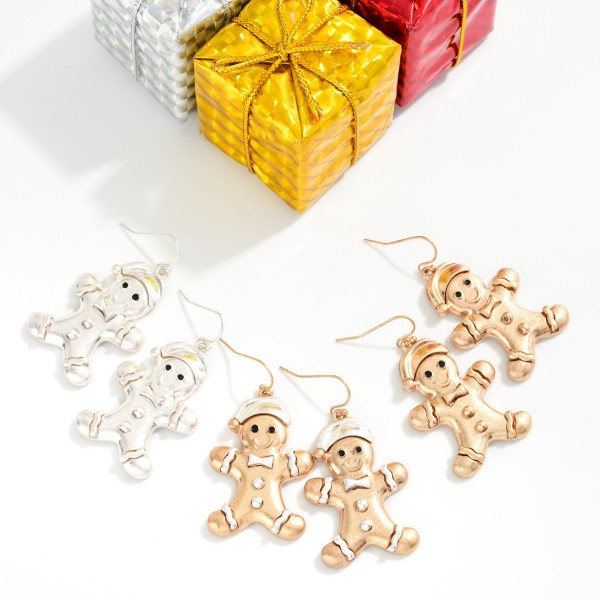 Vintage Metal Gingerbread Man Drop Earrings featuring a smiling gingerbread cookie in a cozy Santa hat, complete with a bow tie, buttons, and icing trim, all in a worn, burnished metal finish. Lightweight fishhook wires keep them easy to wear through long holiday events. A sweet pick for cookie swaps, baking parties, teachers, and holiday markets. Playful and nostalgic, gingerbread designs are a dependable seasonal seller and a perfect stocking stuffer.