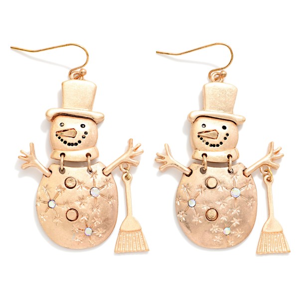 Vintage Metal Snowman Drop Earrings featuring a jolly snowman in a top hat with stick arms, a tiny broom, and etched snowflake details, all in a worn, burnished metal finish. Lightweight fishhook wires keep them comfortable for all day wear. Perfect for winter festivals, classroom parties, and holiday gift exchanges. Whimsical, rustic, and priced right, these are an easy seasonal add on that sells from November through January.