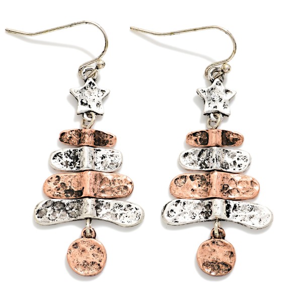 Hammered Metal Christmas Tree Drop Earrings featuring stacked, hammered tiers topped with a tiny star and finished with a dangling round ornament charm. The worn, burnished finish gives a rustic, vintage feel that pairs perfectly with sweaters, flannels, and boots. A charming pick for farmhouse and western boutiques, holiday markets, and gift exchanges. Lightweight on fishhook wires, these sell easily as stocking stuffers and impulse adds.