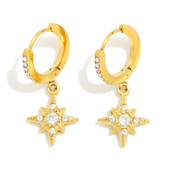 Starburst Charm Huggie Earrings with a cubic zirconia accented hoop and a dangling star charm set with a sparkling center stone. The hinged closure snaps securely for a comfortable, everyday fit. Perfect for adding a little celestial shine to work outfits, date nights, and holiday events. Dainty sparkle huggies are a top gifting item and an easy add on at the register.