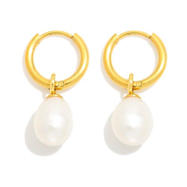 Pearl Drop Huggie Earrings with a glossy faux pearl hanging from a smooth, polished huggie hoop. The hinged closure snaps securely and keeps them comfortable for all day wear. A timeless everyday style that transitions from work to weddings to holiday parties. Classic pearl huggies appeal to every age group and are a dependable seller for gifting all year.