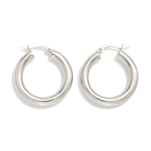 Classic Tube Hoop Earrings featuring a thick, rounded tube hoop with a high polish finish and a secure hinged latch back. Hollow construction keeps the chunky shape surprisingly light, so it stays comfortable for all day wear. A wardrobe essential that pairs with everything from tees to holiday dresses, and an easy gift for any age. Bold everyday hoops are a top reorder item that boutiques never want to run out of.