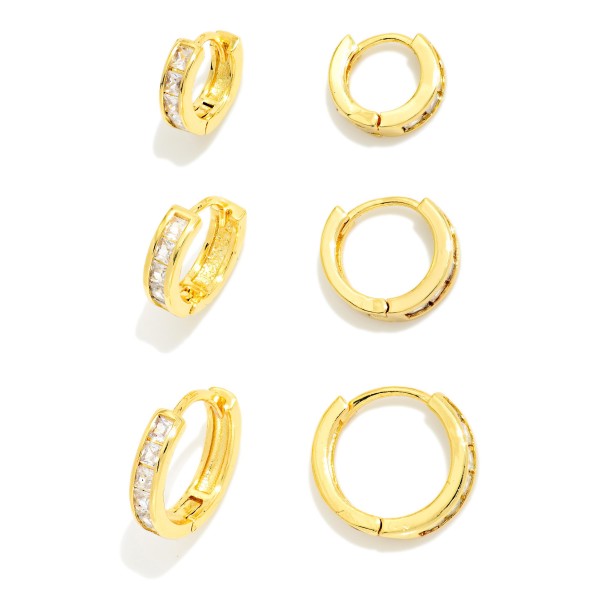 Huggie Hoop Earring Set with three pairs of petite hoops in graduated styles, accented with sparkling cubic zirconia for easy mix and match wear. Hinged closures snap securely and sit close to the ear for comfortable all day wear. Ideal for multiple piercings, layered ear stacks, and everyday polish. Value packed earring sets make a ready to give gift and are a consistent boutique best seller.