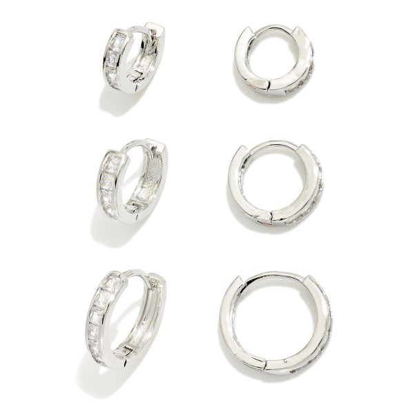 Huggie Hoop Earring Set with three pairs of petite hoops in graduated styles, accented with sparkling cubic zirconia for easy mix and match wear. Hinged closures snap securely and sit close to the ear for comfortable all day wear. Ideal for multiple piercings, layered ear stacks, and everyday polish. Value packed earring sets make a ready to give gift and are a consistent boutique best seller.