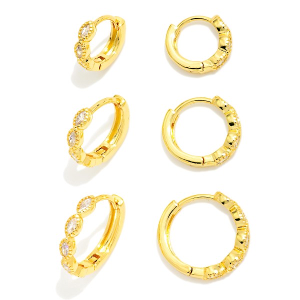 Sparkle Huggie Hoop Earring Set with three pairs of petite hoops, each finished with a different cubic zirconia detail for easy mix and match styling. Hinged closures snap securely and sit close to the ear for comfortable all day wear. Perfect for multiple piercings, curated ear stacks, and simple everyday shine. Earring sets offer great value and make a ready to give gift, so they move quickly in any boutique.