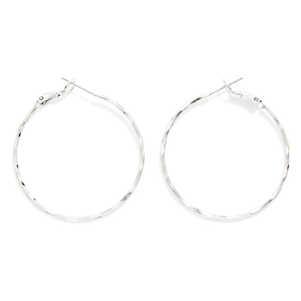 Hammered Wire Hoop Earrings with a lightly faceted texture that catches the light from every angle. The thin, lightweight profile and latch back closure make them comfortable for all day wear. A simple, versatile hoop for everyday outfits, layering with studs, or travel. Minimal hoops at an easy price point are a steady seller that customers buy in multiples.