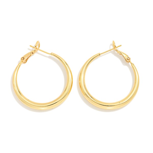 Classic Tube Hoop Earrings with a smooth, rounded profile and secure latch back closure. The polished finish and medium size make them an effortless everyday staple for work, weekends, and nights out. Lightweight construction keeps them comfortable from morning to evening. Timeless hoops are a dependable restock item that every boutique customer reaches for.
