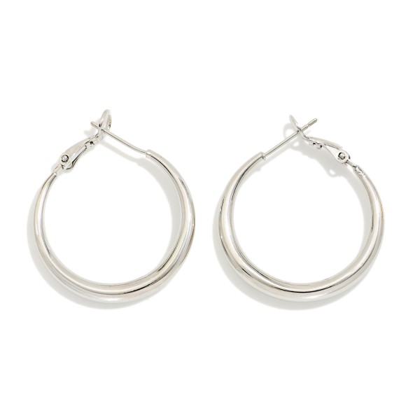 Classic Tube Hoop Earrings with a smooth, rounded profile and secure latch back closure. The polished finish and medium size make them an effortless everyday staple for work, weekends, and nights out. Lightweight construction keeps them comfortable from morning to evening. Timeless hoops are a dependable restock item that every boutique customer reaches for.