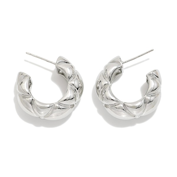 Chunky Twisted Hoop Earrings with a puffy, quilted texture and polished high shine finish. The open C shape and post back keep these bold hoops comfortable for all day wear. An easy everyday statement that pairs with sweaters, tees, and dresses alike. Textured chunky hoops are a year round best seller and a must have basic for any boutique jewelry wall.