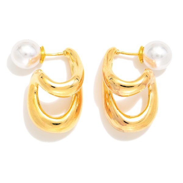 Double Loop Pearl Back Earrings featuring two sculpted, high polish loops that drape below the lobe, finished with a faux pearl ball backing that peeks out behind the ear. The front and back design gives a modern, editorial look from every angle while staying light enough for all day wear. A standout pick for date nights, holiday parties, and fashion forward customers. Statement metals with a pearl twist are trending hard and make a strong impulse sell.