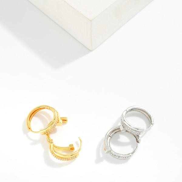Pave Nail Huggie Hoop Earrings featuring a sleek wraparound nail design with a polished hex head and a row of sparkling cubic zirconia stones along the front. The hinged huggie closure snaps securely and sits close to the ear for a modern, high end look. A trend right gift for birthdays, graduations, and anyone who loves elevated everyday jewelry. Luxe inspired huggies are a strong seller at an accessible price point.
