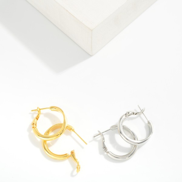 Metal Tone Tube Hoop Earrings Featuring Pressed Metal Detail 

- Gold Dipped
- Approximately .75" D