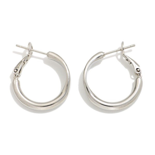 Metal Tone Tube Hoop Earrings Featuring Pressed Metal Detail 

- Gold Dipped
- Approximately .75" D