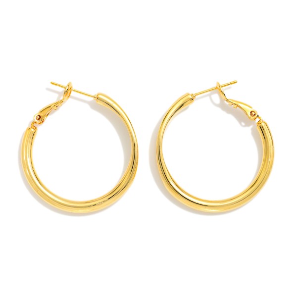 Metal Tone Tube Hoop Earrings Featuring Pressed Metal Detail 

- Approximately 1" D