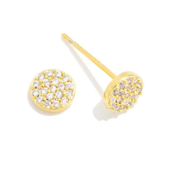 Pave Disc Cubic Zirconia Stud Earrings featuring a petite round disc densely set with sparkling stones for maximum shimmer in a minimal shape. The flat, low profile design sits comfortably against the ear and stacks easily with huggies and climbers. A polished everyday staple that works for the office, weekends, and special occasions alike. Simple sparkle studs make easy gifts and dependable reorders for any boutique jewelry case.