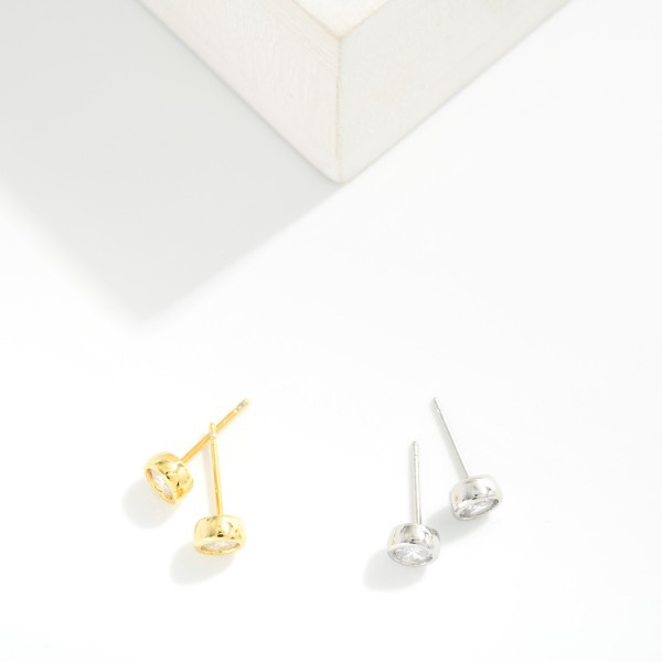 Bezel Set Cubic Zirconia Stud Earrings featuring a brilliant round stone wrapped in a smooth, polished bezel for a clean, modern look. The low profile setting sits close to the ear, stays comfortable for all day wear, and works beautifully in second and third piercings. An everyday essential that pairs with everything and makes an easy gift for birthdays, graduations, and holidays. Classic studs like these are year round staples that reorder again and again.