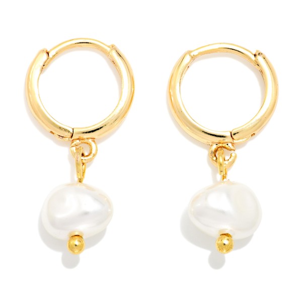 Baroque Pearl Huggie Drop Earrings featuring an organic shaped faux pearl dangling from a polished huggie hoop with a secure hinged closure. The irregular pearl shape gives a modern, artisan feel, while the snug huggie keeps them comfortable from morning meetings to evening plans. A versatile gift for brides, bridesmaids, and anyone who loves classic polish with a twist. Pearl huggies are a top trend, making these an easy, fast turning add on.