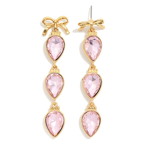 Bow Teardrop Crystal Drop Earrings with a polished bow post top and three faceted pear cut stones linked in delicate bezels. The bow detail meets classic sparkle for a feminine statement that moves with every turn. Made for holiday parties, weddings, birthdays and date nights. Bow details are a shopper favorite right now, and these stand out on any jewelry display.