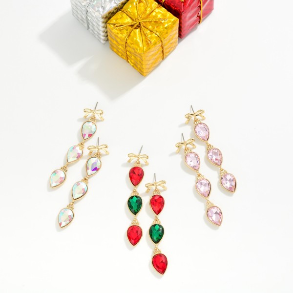 Bow Teardrop Crystal Drop Earrings with a polished bow post top and three faceted pear cut stones linked in delicate bezels. The bow detail meets classic sparkle for a feminine statement that moves with every turn. Made for holiday parties, weddings, birthdays and date nights. Bow details are a shopper favorite right now, and these stand out on any jewelry display.