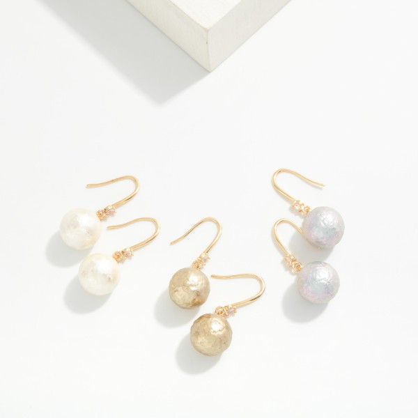 Cotton Pearl Drop Earrings with a soft textured pearl bead and a tiny crystal accent on lightweight fishhook wires. The matte pearl finish feels modern and organic while staying light enough for all day wear. A pretty everyday pick for the office, brunch, weddings and holiday gatherings. Pearl drops are a year round staple that sell to every age.