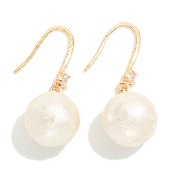 Cotton Pearl Drop Earrings with a soft textured pearl bead and a tiny crystal accent on lightweight fishhook wires. The matte pearl finish feels modern and organic while staying light enough for all day wear. A pretty everyday pick for the office, brunch, weddings and holiday gatherings. Pearl drops are a year round staple that sell to every age.