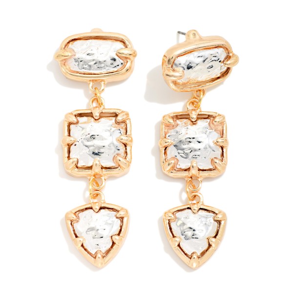 Two Tone Tiered Drop Earrings linking three hammered metal stones, an oval, a square and a shield shape, each held in a contrasting prong setting. The mixed metal finish and stacked shapes give a bold, collected look that still feels lightweight. A standout pick for holiday parties, weddings and dressing up everyday outfits. Mixed metal statement drops are a quick sell for shoppers who want one pair that goes with everything.