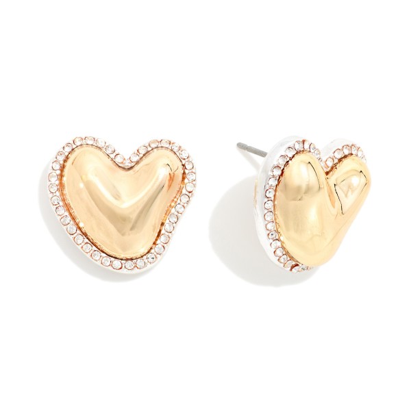Rhinestone Halo Heart Stud Earrings with a puffy hammered metal heart framed by a sparkling crystal border. The organic heart shape and pave edge make them feel special, while post backs keep them secure for all day wear. A sweet pick for Valentine's Day, Galentine's gifts, birthdays and everyday sparkle. Heart studs sell year round and make an easy add on at the register.
