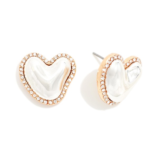 Rhinestone Halo Heart Stud Earrings with a puffy hammered metal heart framed by a sparkling crystal border. The organic heart shape and pave edge make them feel special, while post backs keep them secure for all day wear. A sweet pick for Valentine's Day, Galentine's gifts, birthdays and everyday sparkle. Heart studs sell year round and make an easy add on at the register.