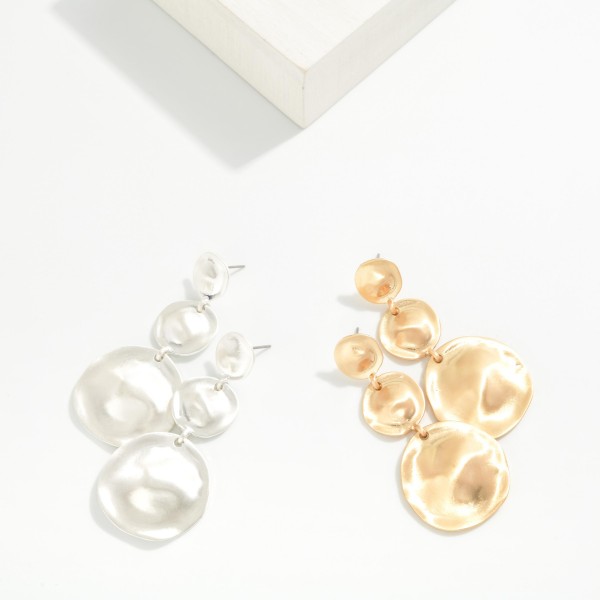 Graduated Disc Drop Earrings linking three hammered metal discs that grow from a small post top to an oversized coin. The wavy texture in a soft matte finish catches the light without feeling flashy, and the build stays light for all day wear. Easy to style with knits, denim and holiday dresses. A sculptural statement drop that fits right into the organic metal trend.