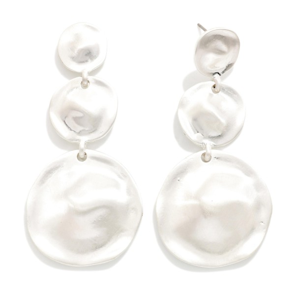 Graduated Disc Drop Earrings linking three hammered metal discs that grow from a small post top to an oversized coin. The wavy texture in a soft matte finish catches the light without feeling flashy, and the build stays light for all day wear. Easy to style with knits, denim and holiday dresses. A sculptural statement drop that fits right into the organic metal trend.