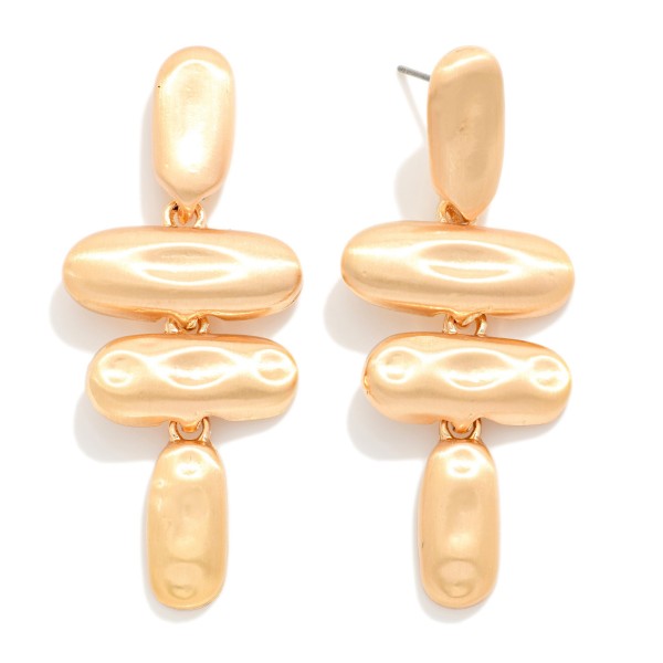 Molten Metal Drop Earrings stacking four organic oval shapes with a hammered, liquid look in a soft matte finish. Bold but lightweight, they hang from post tops for a sculptural statement that still feels easy to wear. Great for holiday parties, art walks, date nights and dressing up a simple sweater. Sculptural metal styles are trending, and this pair delivers the look at a boutique friendly price.