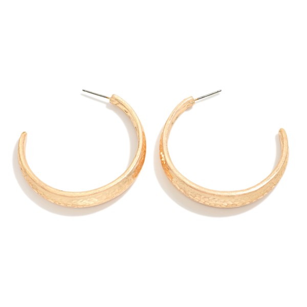 Brushed Metal Hoop Earrings with a wide tapered open hoop in a soft satin finish. The lightweight build and post backs make them comfortable for all day wear, and the polished edge adds a subtle shine. An everyday essential that pairs with sweaters, denim and workwear alike. Classic metal hoops are a dependable reorder for any boutique jewelry wall.