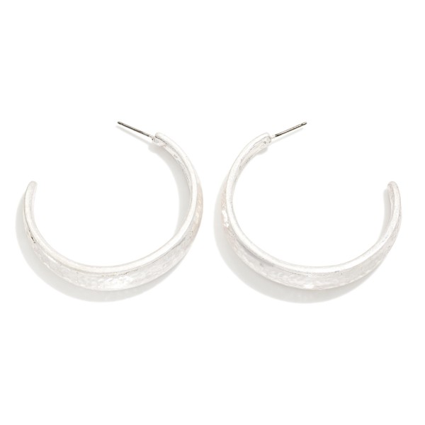 Brushed Metal Hoop Earrings with a wide tapered open hoop in a soft satin finish. The lightweight build and post backs make them comfortable for all day wear, and the polished edge adds a subtle shine. An everyday essential that pairs with sweaters, denim and workwear alike. Classic metal hoops are a dependable reorder for any boutique jewelry wall.