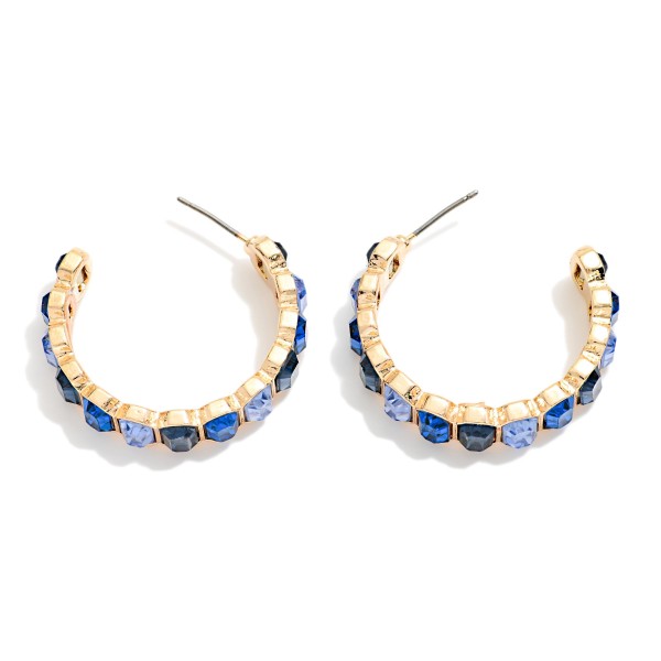 Crystal Lined Hoop Earrings with a row of round faceted stones set in polished bezels all the way around a slim open hoop. Post backs and a lightweight build make them easy to wear from day to night. A sparkling choice for holiday events, weddings, date nights and everyday glam. Classic jeweled hoops at an easy price that keep boutiques reordering.