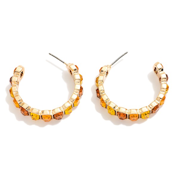 Crystal Lined Hoop Earrings with a row of round faceted stones set in polished bezels all the way around a slim open hoop. Post backs and a lightweight build make them easy to wear from day to night. A sparkling choice for holiday events, weddings, date nights and everyday glam. Classic jeweled hoops at an easy price that keep boutiques reordering.
